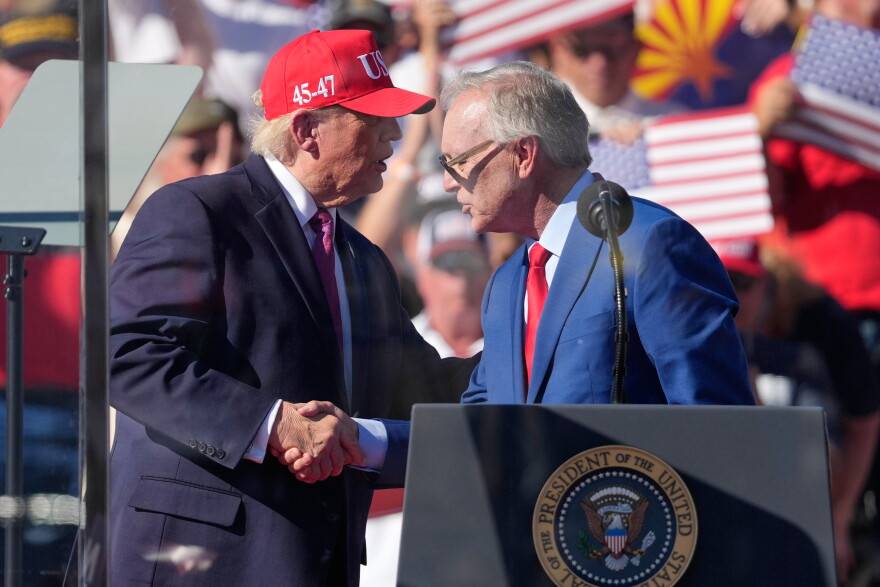 President Donald Trump greets Arizona gubernatorial candidate Rep. Andy Biggs, R-Ariz., at a campaign rally at the Laughlin Bullhead International Airport, Wednesday, Oct. 14, 2026, in Bullhead City, Ariz.