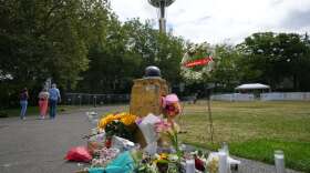 A memorial for victims of a July 26 shooting is seen at Seattle Center during the Bite of Seattle food festival, Tuesday, July 28, 2026, in Seattle. (AP Photo/Lindsey Wasson)