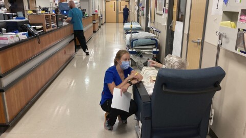 A nurse talks to a patient in the emergency room at Salem Hospital in Salem, Ore., on Aug. 20, 2021.