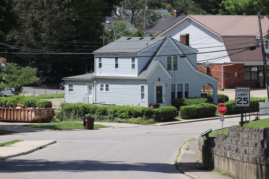 A Richmond street slopes downward toward University Drive. Two people drowned in the basement of the residence at the bottom after a flash flood submerged the property on June 27.