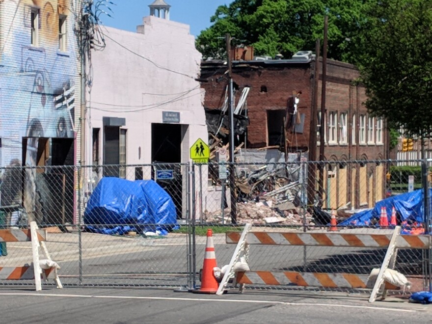 A block of North Duke Street remains closed more than two weeks after a gas leak sparked an explosion that killed two and damaged 15 buildings.