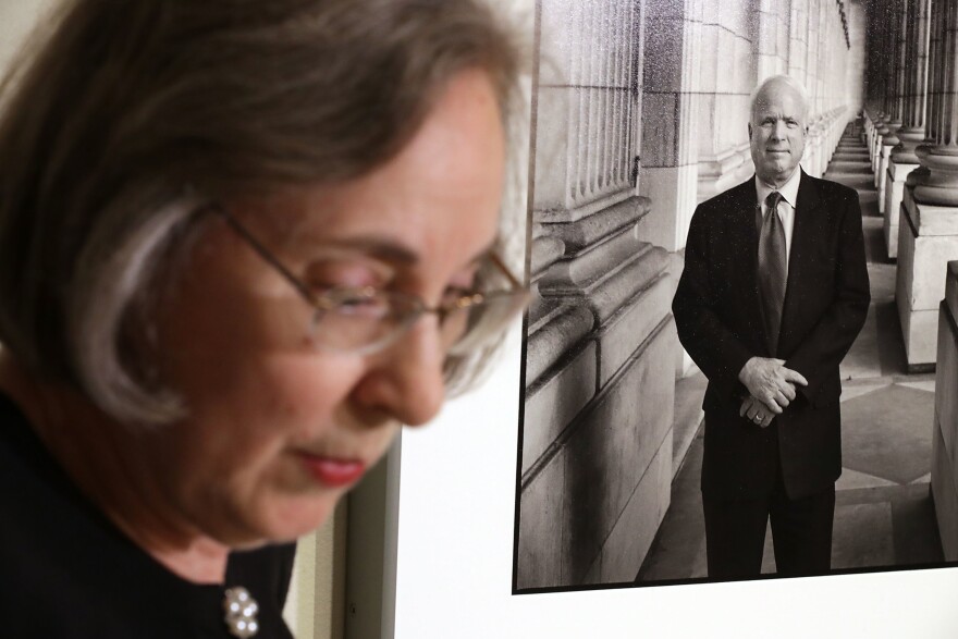 Smithsonian National Portrait Gallery curator Ann Shumard talks about a photograph of Sen. John McCain, R-Ariz., that was displayed at the gallery on Monday. The former presidential candidate died Saturday of brain cancer at the age of 81. This is the first time that the 2005 image of McCain by photographer Steve Pyke has been displayed in the gallery.