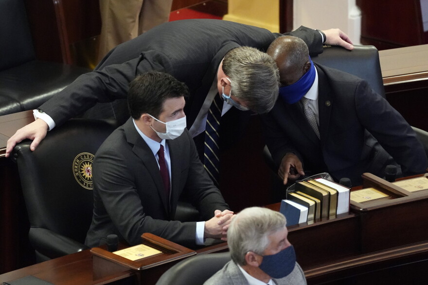 In this Jan. 13, 2021 file photo, Sen. Mike Woodard, D-Durham, speaks with Sen. Ben Clark, D-Hoke, right, and Sen. Jeff Jackson, D-Mecklenburg in the Senate chamber during the opening session of the North Carolina General Assembly in Raleigh, N.C. Jackson has announced he is running for the U.S. Senate in 2022. Jackson unveiled his bid on Tuesday, Jan, 26, 2021.