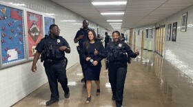 Dr. Brenda Cassellius, center, walks with school resource officers at Marshall High School on Aug. 28, 2025.