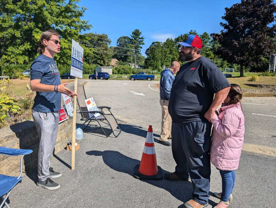 Voter Joshua Peruse speaks to Republican candidate James Thibault outside Franklin Middle School