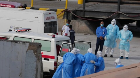 Health workers in protective gear evacuate patients from the MV Hondius cruise ship into an ambulance at a port in Praia, Cape Verde, on Wednesday, May 6, 2026.