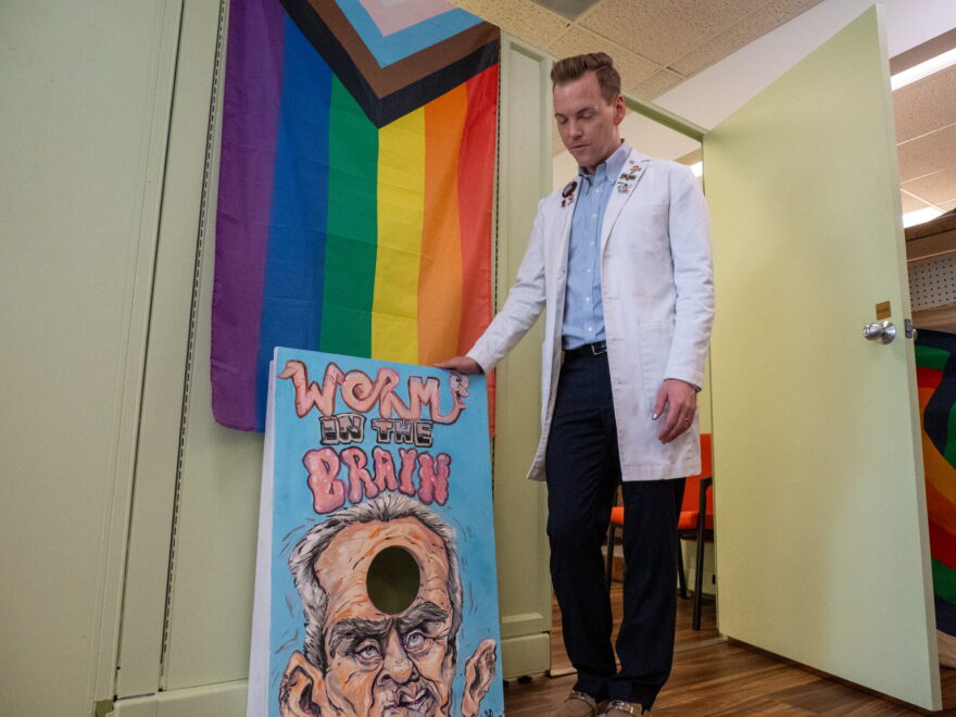 Pharmacist Will Anderson, owner of Orchards Drug in Lawrence, shows a cornhole set at his store that pushes back against anti-vaccine information put out by U.S. Health and Human Services Secretary Robert Kennedy Jr.