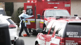 Ambulance staff prepare to transport a patient from the Life Care Center nursing home where some patients have died from COVID-19 in Kirkland, Washington.