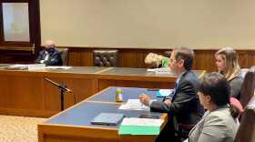 A photo of a Frank Edleblut speaking to the new Education Savings Account legislative oversight committee. Edleblut is in profile, flanked by two people on either side.