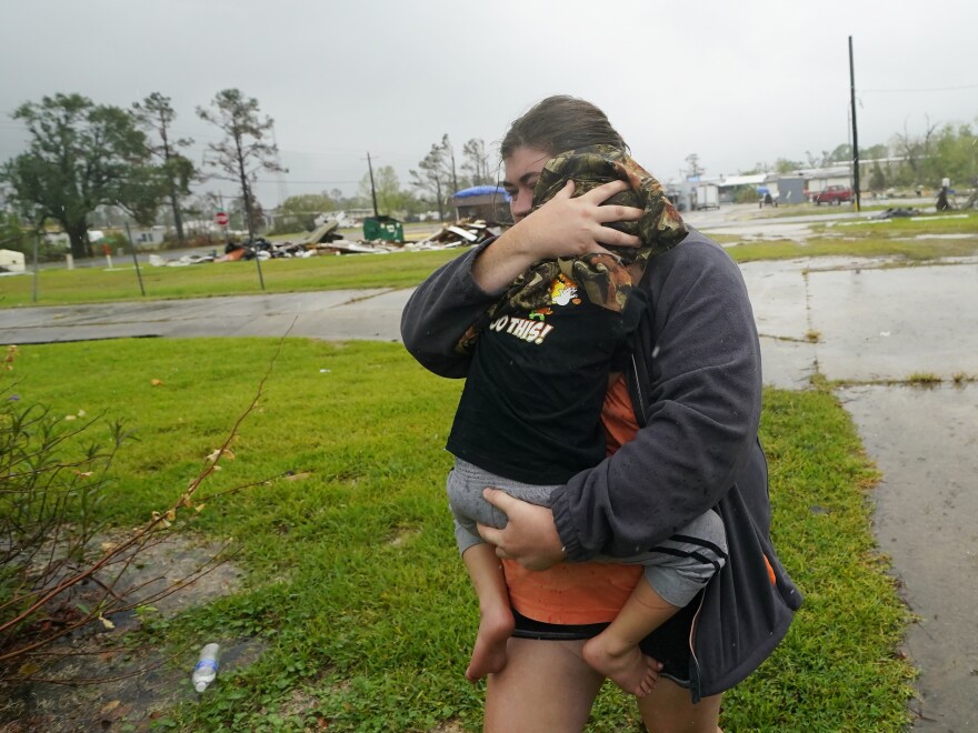 Danielle Fontenot runs to a relative's home in the rain with her son Hunter ahead of Hurricane Delta in Lake Charles, La., in October. The 2021 Atlantic Hurricane Seasons begins June 1.