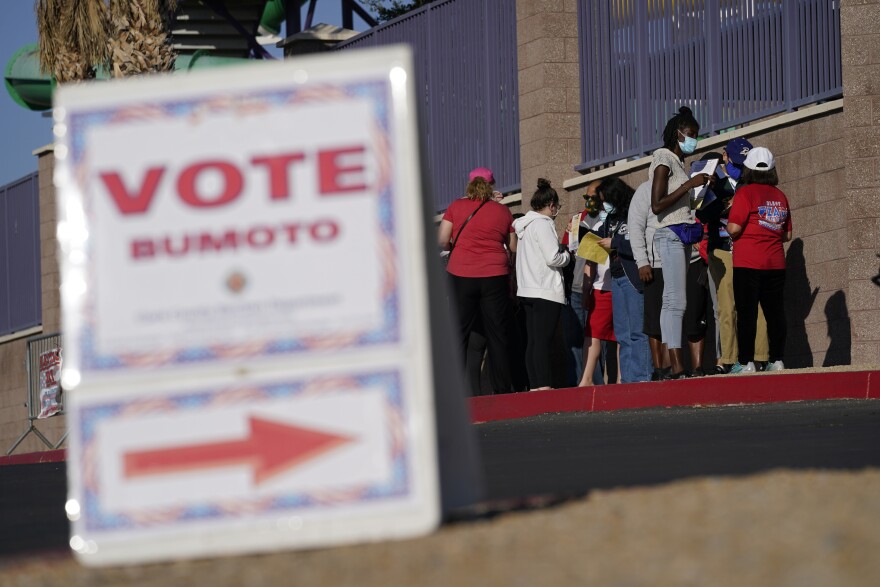 FILE - People wait in line to vote at a polling place on Election Day, Nov. 3, 2020, in Las Vegas. (AP Photo/John Locher, File)