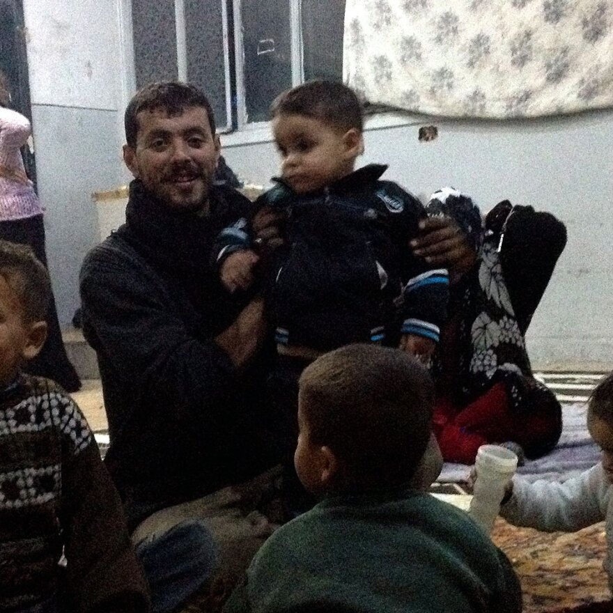 Ahmed (center) is staying at the school but will soon join his brother Yehya to go fight with anti-government rebels to earn money.