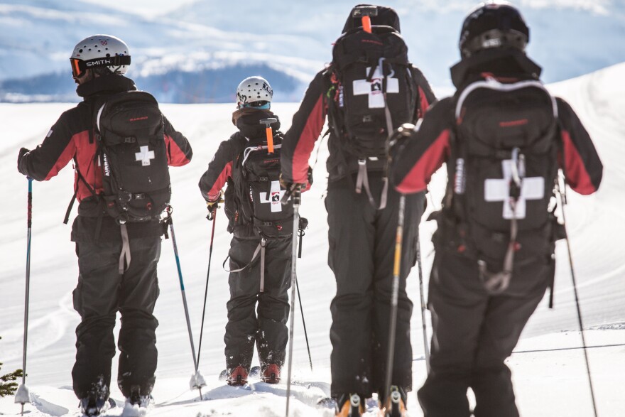 A photo showing ski patrollers skiing away from the camera at Jackson Hole Resort in Wyoming. 