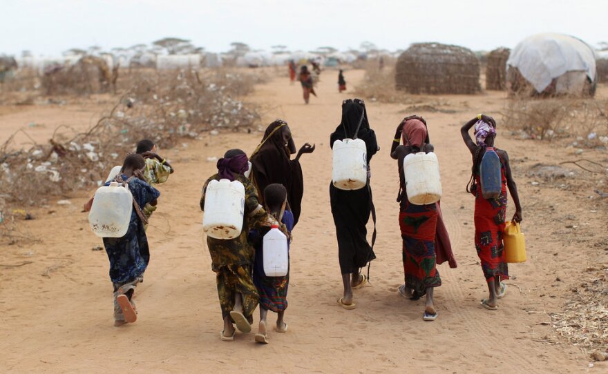 Somali refugees return from collecting water July 22 at the edge of the Dagahaley refugee camp, also part of the Dadaab settlement.