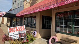 A sign opposing the Indiana Department of Natural Resources' plan to demolish the historic Naragon Barn at Potato Creek State Park, in front of Over the Top Bakery & Cafe in North Liberty. The barn belonged to Raymond Naragon in the early 1970s when the state acquired the land for the park. His granddaughters, Annette Martin and Vivian Bolen, own the bakery.