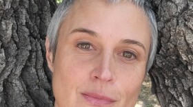 a close-up photo of julia butterfly hill, a white woman with short, gray hair and brown eyes.