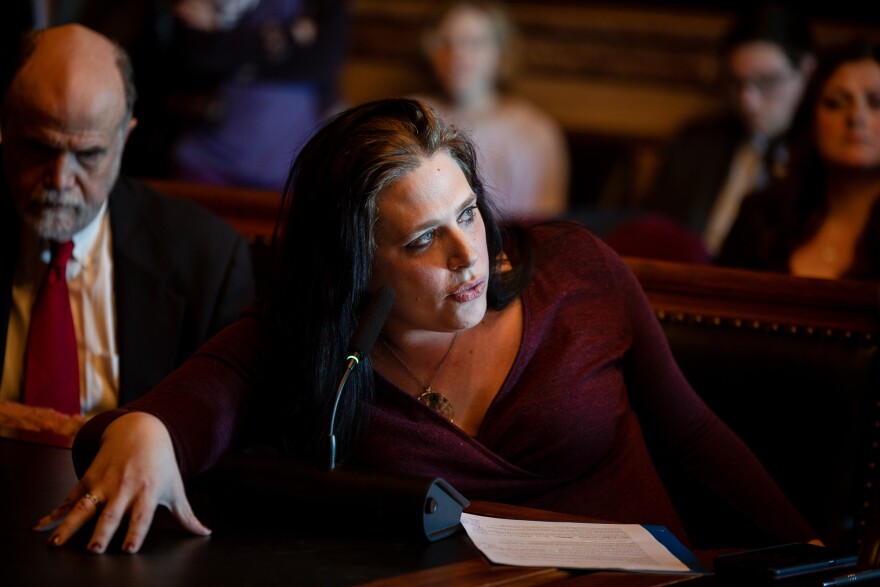 Woman speaks while sitting at a wooden table