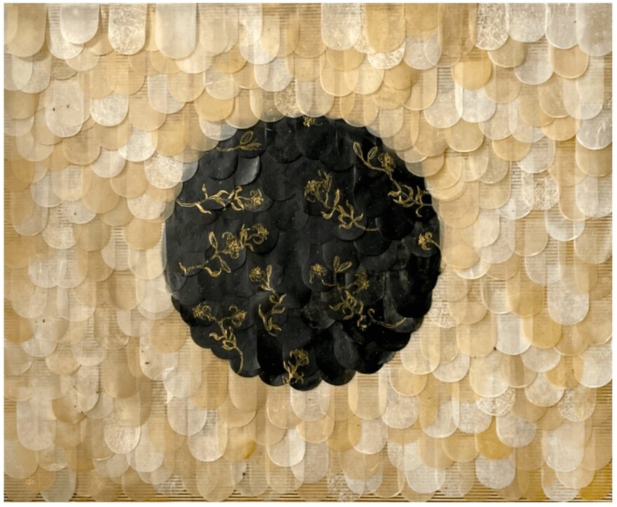 Visual artwork, yellow/white "scales" with a black circle in the center