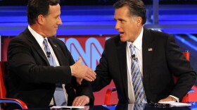 Republican presidential candidates Rick Santorum and Mitt Romney talk after participating in a debate on Feb. 22, 2012 in Mesa, Arizona. The debate was the last one scheduled before voters head to the polls in Michigan and Arizona's primaries on Feb. 28 and Super Tuesday on March 6. 