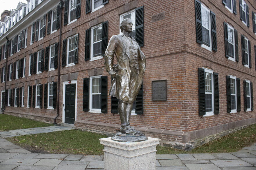A statue of Nathan Hale, a Yale University class of 1773 graduate, with his hands and ankles bound with rope and the inscription "I only regret that I have but one life to lose for my country" is in front of Hale's former dormitory Connecticut Hall on the college's campus in New Haven, Connecticut, on Monday, December 4, 2023. (AP Photo/Ted Shaffrey)