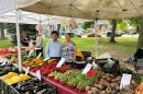Fong Chang and Ue Xiong posing in front of the stand in the Walker Square Market.