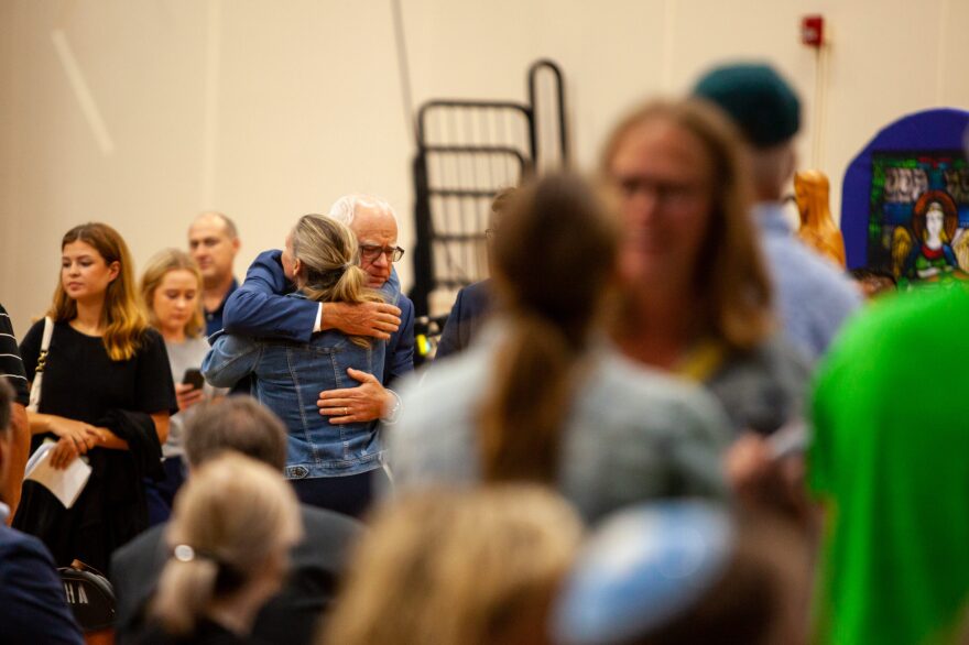 Gov. Tim Walz embraces a mourner at the Academy of the Holy Angels in Richfield during a vigil for the two children who were killed and the several children and parishioners injured in a shooting at Annunciation Church on Wednesday, Aug. 27, 2025, in south Minneapolis.