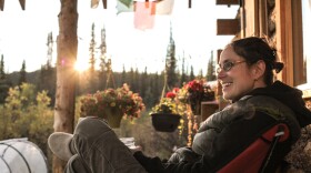 Kate Neville enjoys the summer view from her off-the-grid cabin near Atlin, British Columbia.