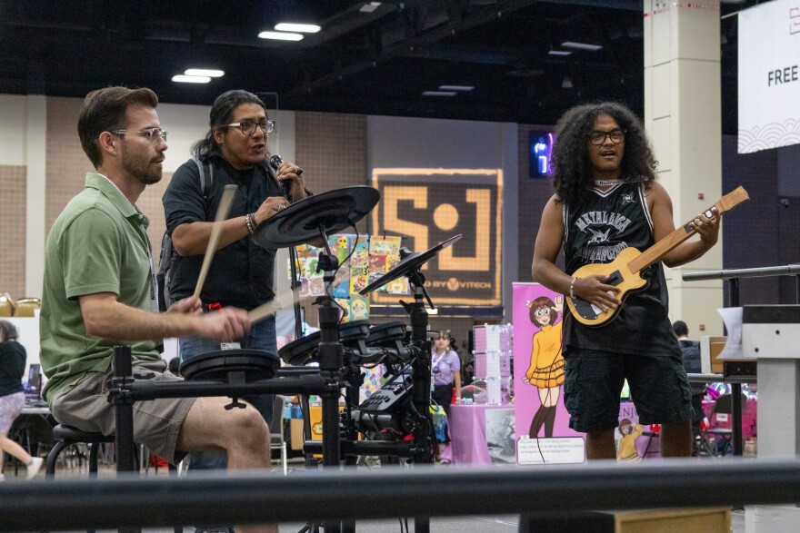 San Japan participants play Guitar Hero
