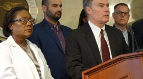Marion County Public Health Director Virginia Caine, left, listens as Indianapolis Mayor Joe Hogsett explains why the city is closing all public schools on Thursday, March 12, 2020 at the City-County Building.