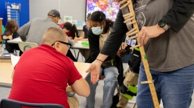 Special education teacher Kim Handley assists a student while paraprofessionals Kathleen Bitson and Brandon Swain work with other students at Tulsa Public Schools' Skelly Elementary.