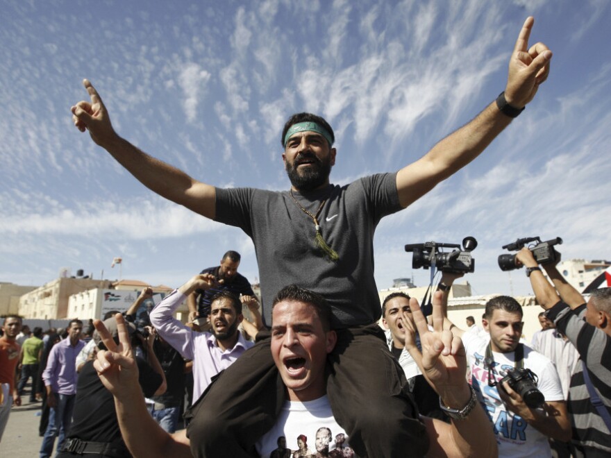 <p>Palestinians celebrate the release of prisoners in the West Bank city of Ramallah. A total of 477 Palestinians were freed Tuesday, with 550 more slated to be released in two months.</p>