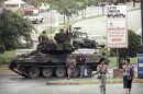 A U.S. Army tank forms a roadblock off a traffic circle leading to the Vatican Embassy in Panama City 