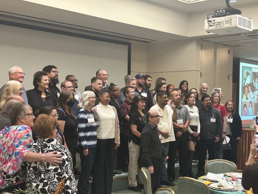 Eddie Anguiano taking a group photo with patients who have received infant heart transplants and their families.