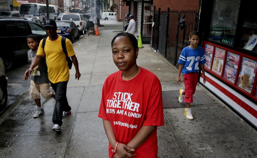 Shantel Walker stands outside a fast food restaurant June 19 in Brooklyn, New York. Walker, who made $8.25 per hour at a Brooklyn pizzeria, was part of a broad campaign by fast food workers to advocate for higher minimum wages.