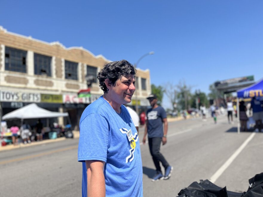 Spencer Toder, a Democrat running for Missouri’s open U.S. Senate seat, speaks with residents at the Black Wall Street 314 Festival in Wellston Loop in St. Louis on June 25, 2022.