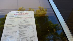 A "Notice to Vacate" is seen in the window of a foreclosed home. (Robyn Beck/AFP/Getty Images)