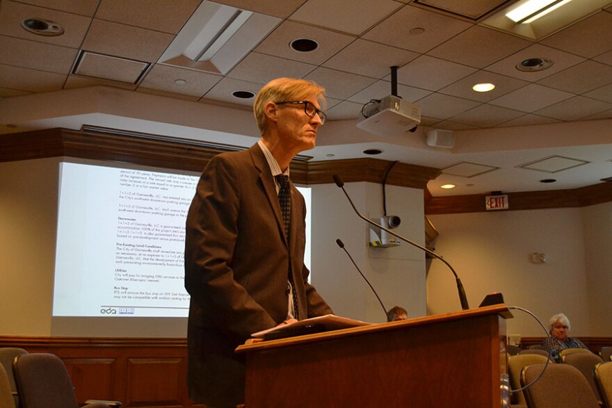 Erik Bredfeldt explains the contract to the City Commission and points out areas of interest. (Eve Rosen/WUFT News)