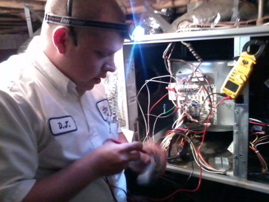 D.J. Teate with Morris Jenkins, servicing a customer's furnace. Photo: Scott Graf