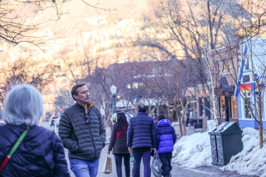 People walking around a snowy downtown area.
