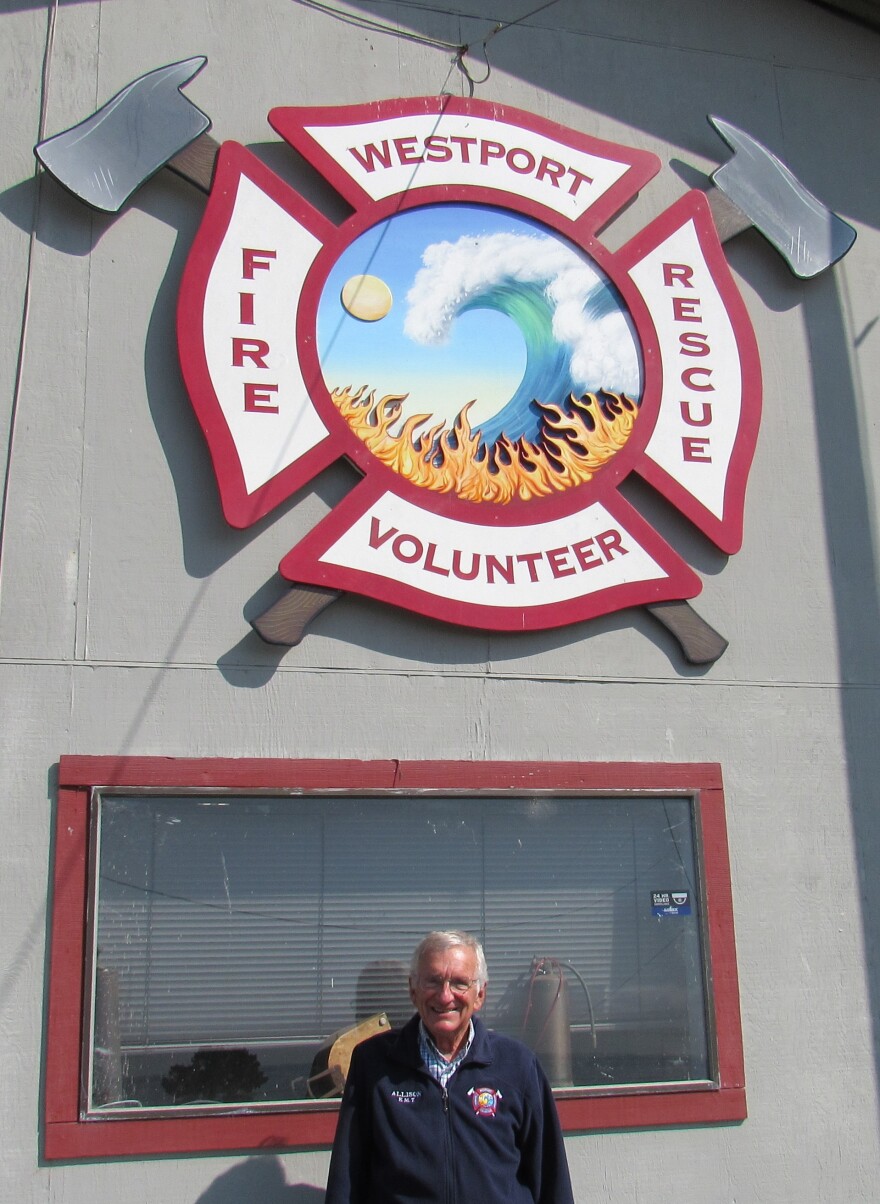 PIO John Allison pose in front of the  Westport Volunteer Fire Department building 