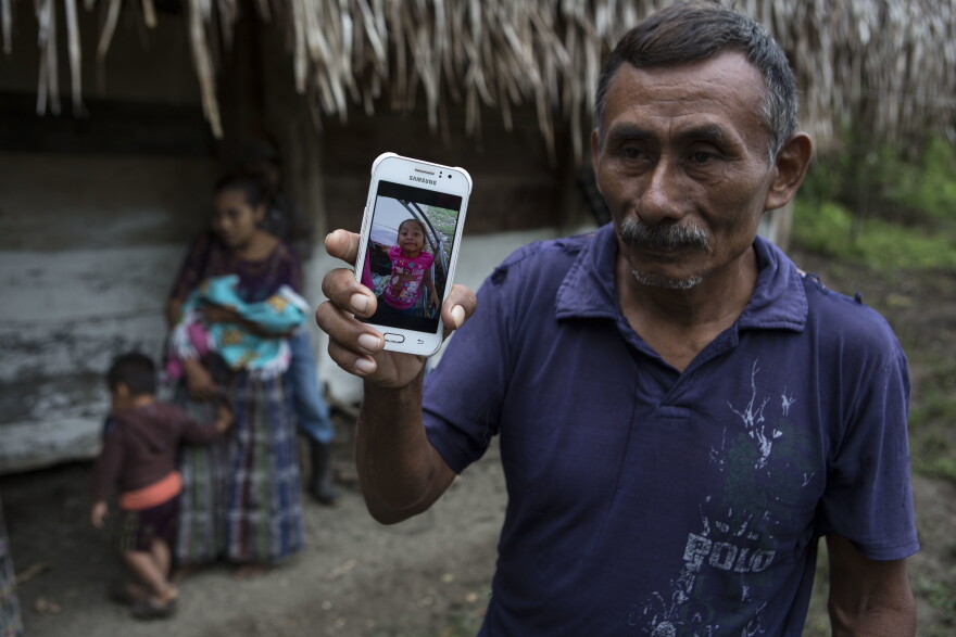 Domingo Caal Chub, 61, holds a smartphone displaying a photo of his granddaughter, Jakelin Amei Rosmery Caal Maquin, in Raxruha, Guatemala, on Dec. 15, 2018. 