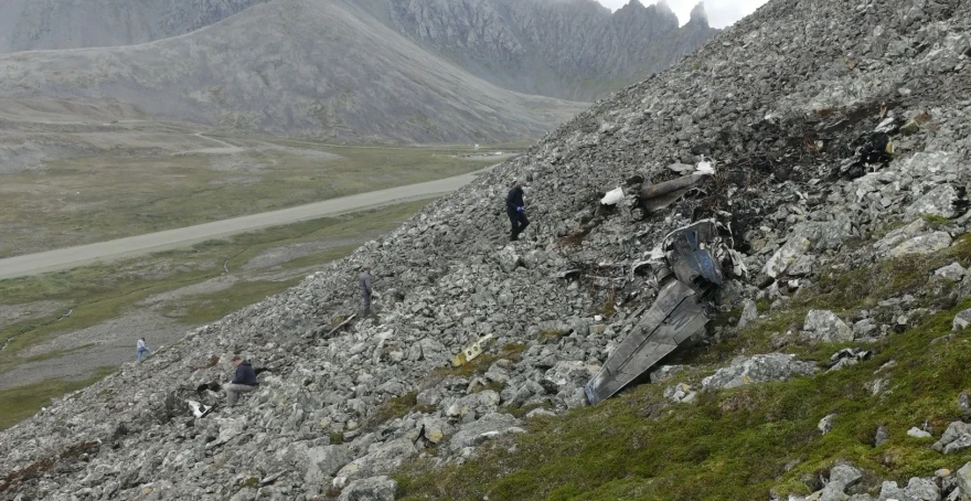 Investigators with the National Transportation Safety Board are seen on Aug. 23, 2026 documenting wreckage of a Cessna 441 that crashed on Cape Newenham in Southwest Alaska three days earlier, killing all eight people on board.