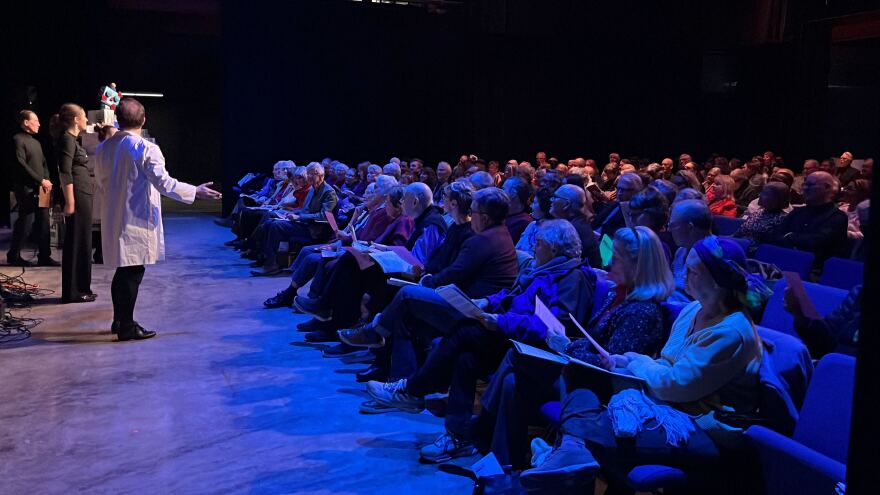 The audience read from pink slips and followed the conductor for "Simultaneous Poetry".