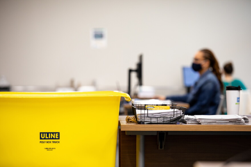File photo of workers at the Durham County Board of Elections processing absentee ballot requests while maintaining safety during the coronavirus pandemic in Durham, N.C. on Tuesday, Aug. 18, 2020. 