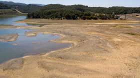 Kayakers make a long trek to the water's edge at a drought-stricken Lake Mendocino, currently at 29% of normal capacity, in Ukiah, Calif., Sunday, May 23, 2021. California Gov. Gavin Newsom declared a drought emergency for most of the state.