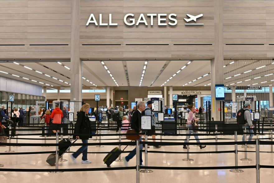 Passenger are heading to the security checkpoint at the Kansas City International Airport the Monday before Thanksgiving.