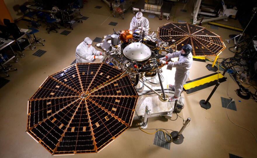 NASA's InSight Mars lander sits with its solar arrays deployed in a Lockheed Martin clean room near Denver.
