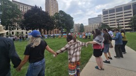 Activists, including tribal community members, opposed to the operation of the Line 5 oil and natural gas liquids pipeline, rally at the Michigan Capitol on Wednesday, August 27.