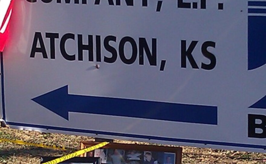 Near entrance to site of blast that killed six, tributes to dead workers were set beneath company signage.