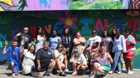 A group of local artists celebrate the completion of a mural at Sheehan-Basquil Park in central Manchester on Saturday, Aug. 15, 2025